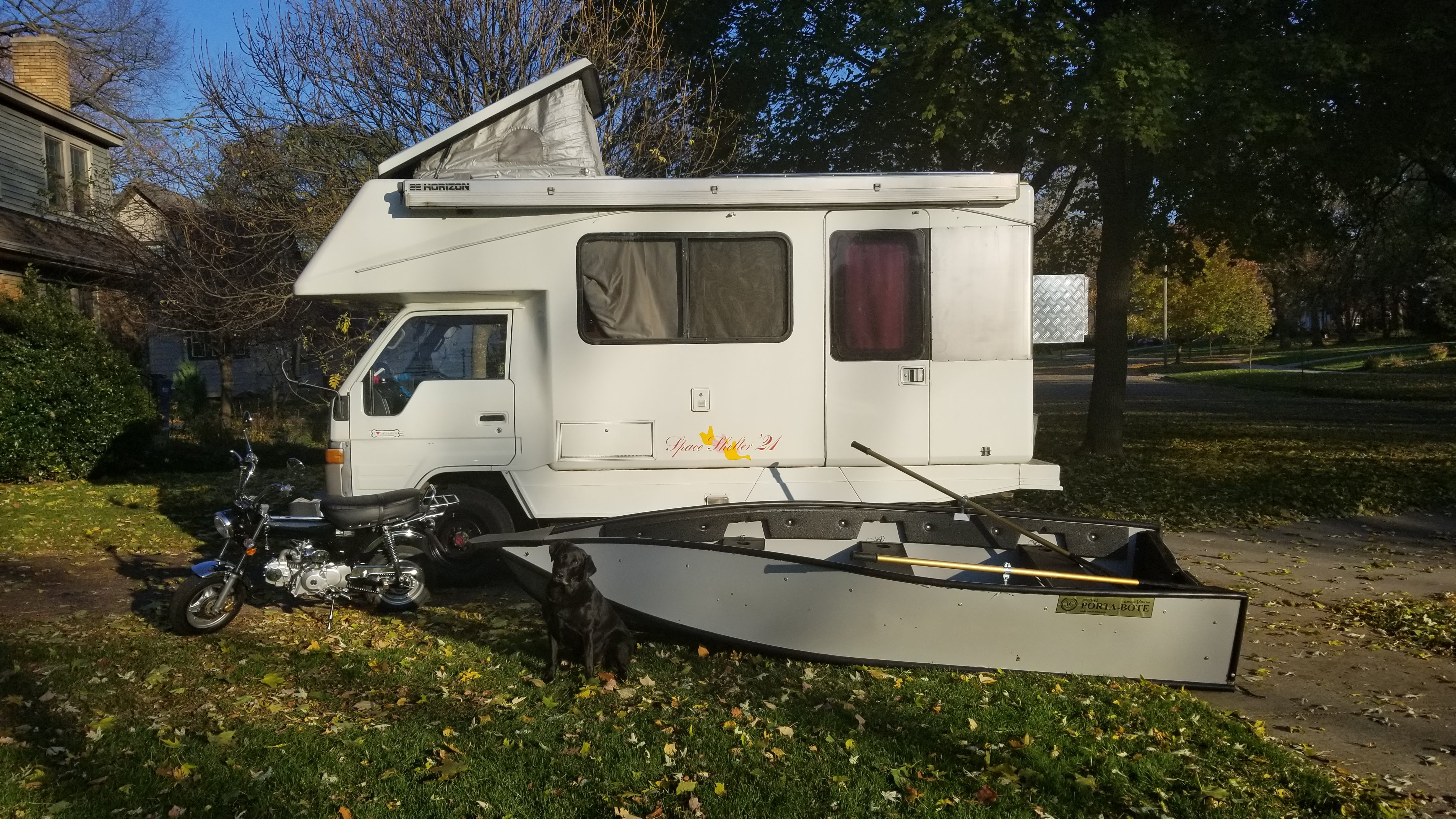 Vanly RV parked near a home